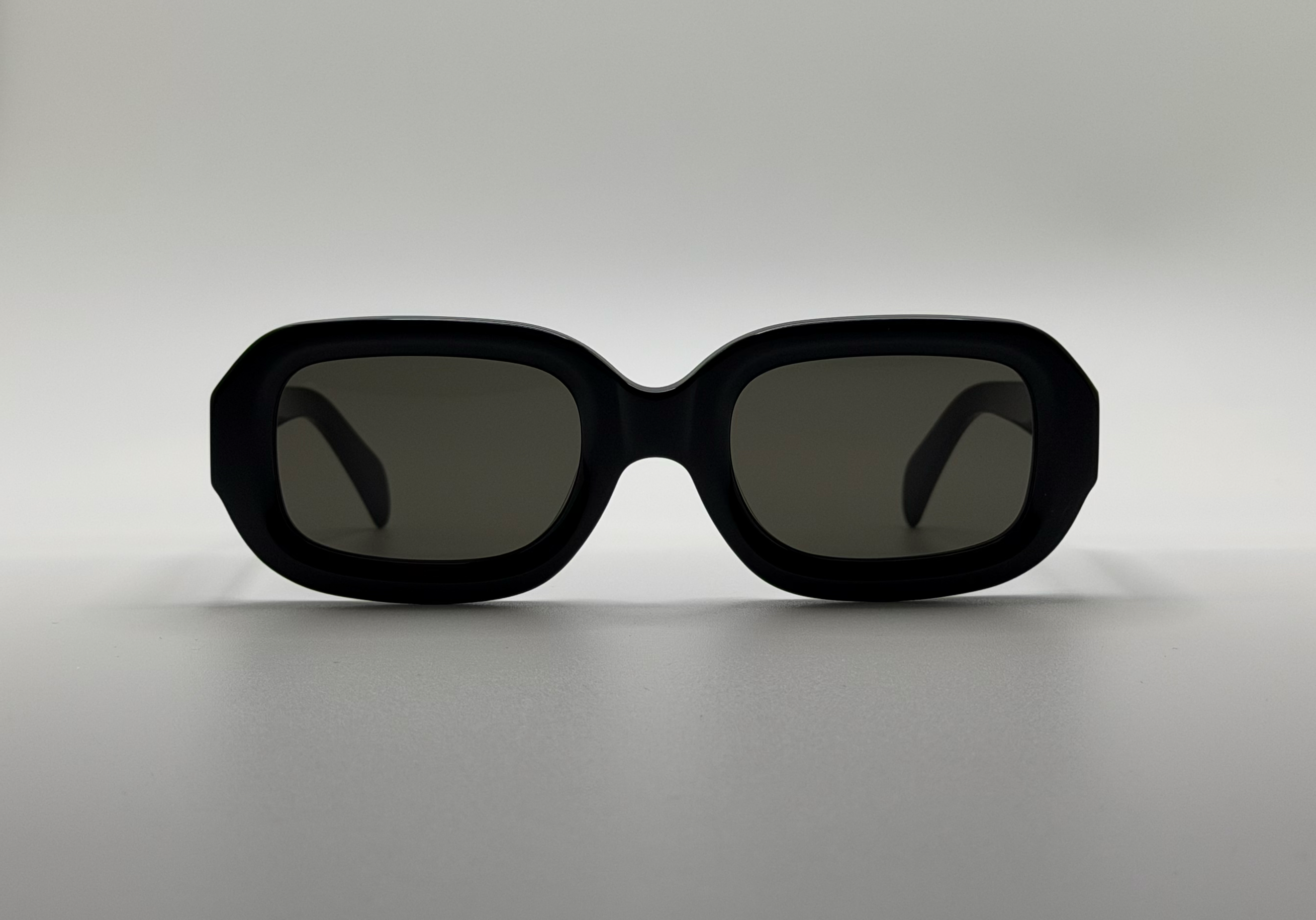 Black sunglasses on a light gray background