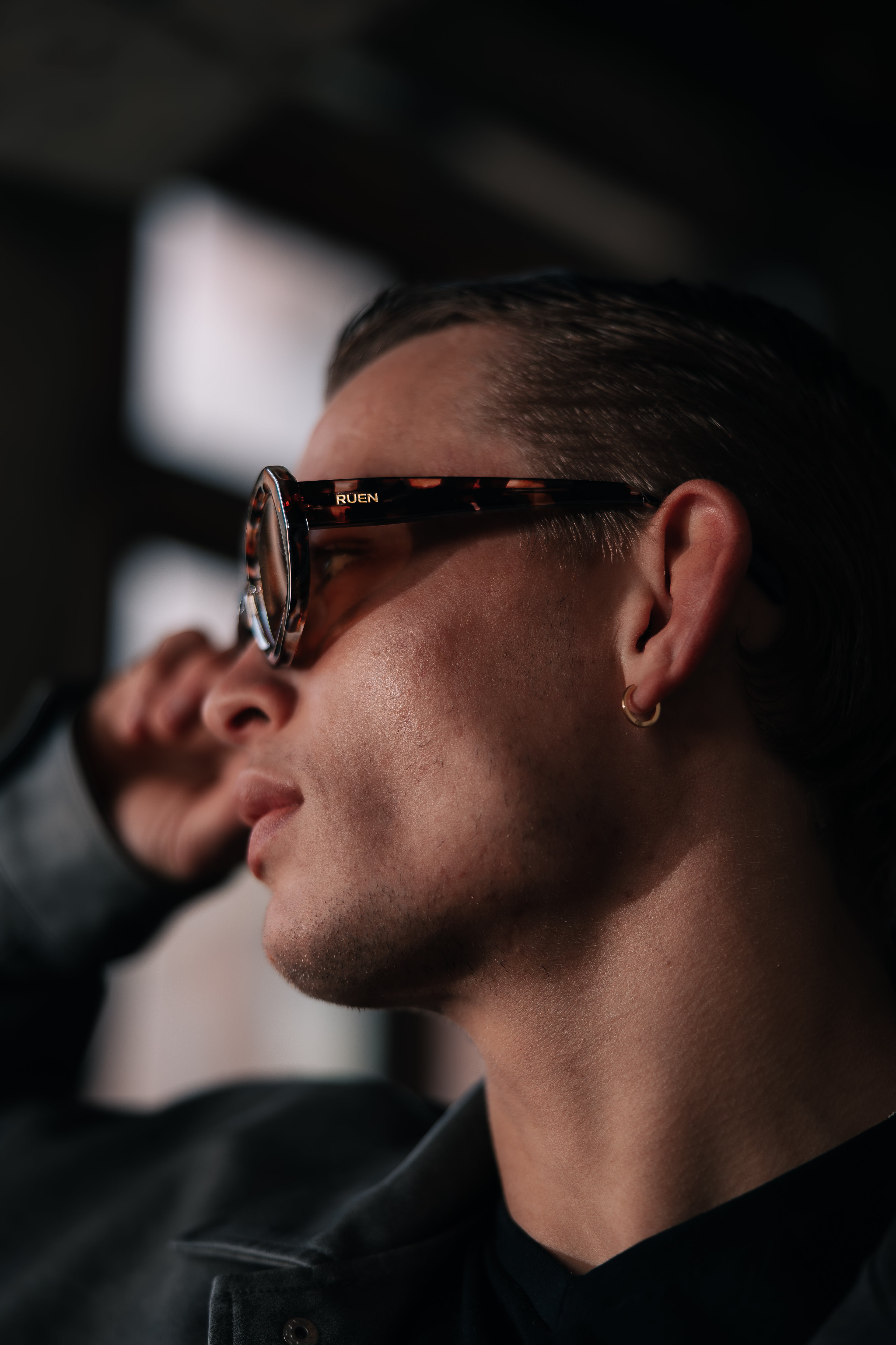 Close-up of a person wearing sunglasses with a blurred background