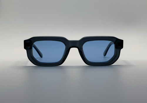 Blue sunglasses with blue lenses on a gray background