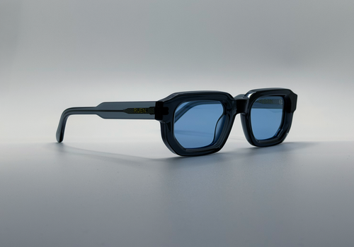 Blue sunglasses with blue lenses on a gray background