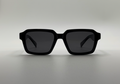 Black sunglasses on a light gray background