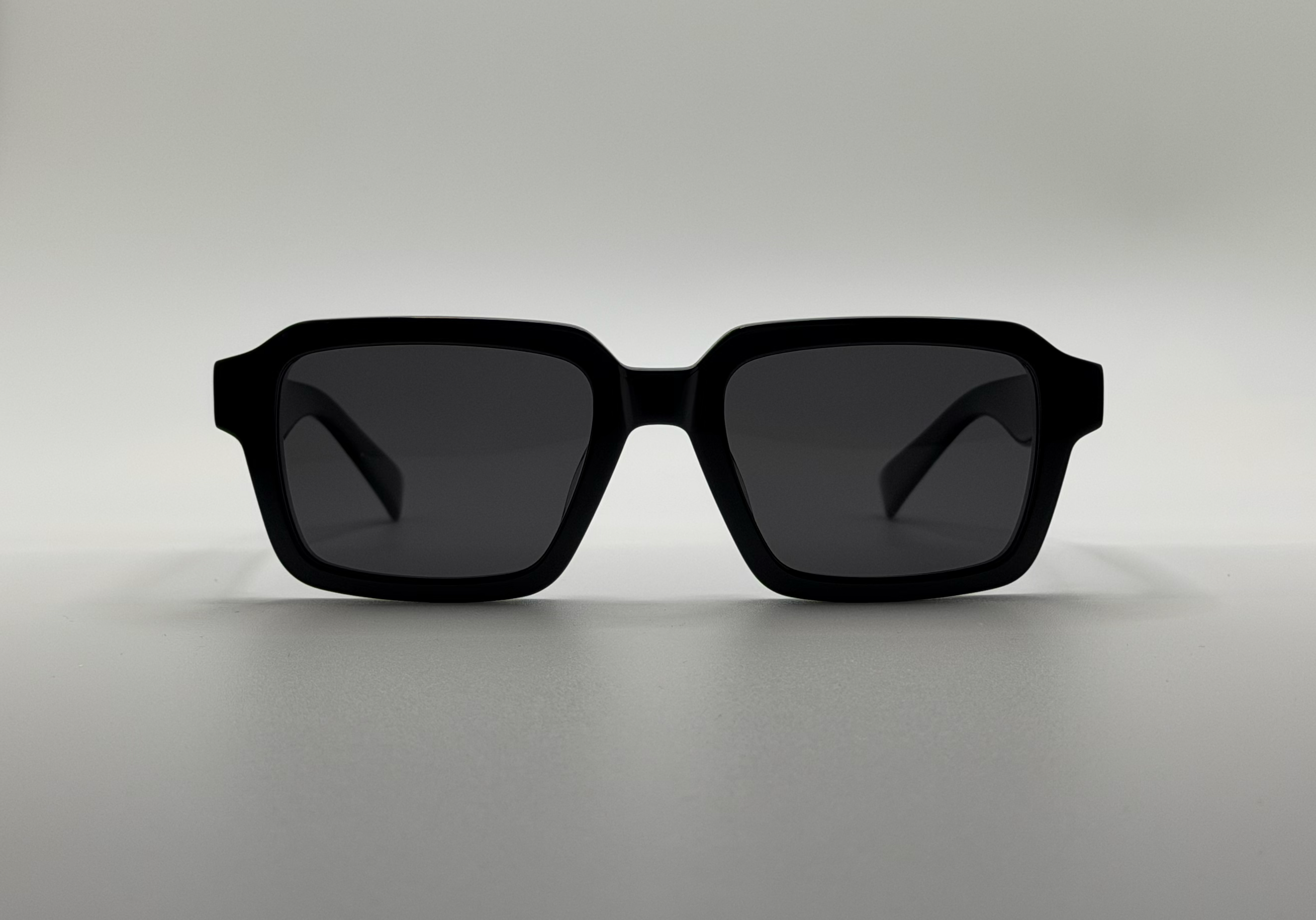 Black sunglasses on a light gray background