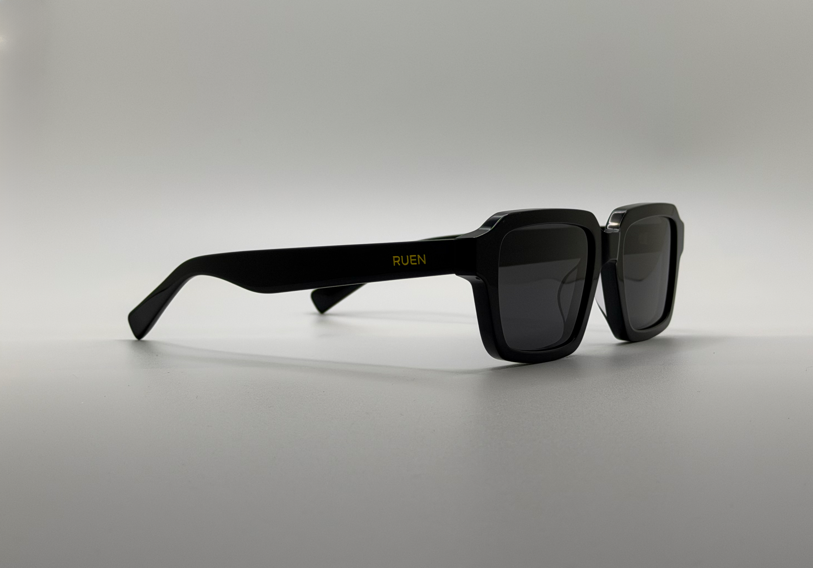 Black sunglasses on a light gray background
