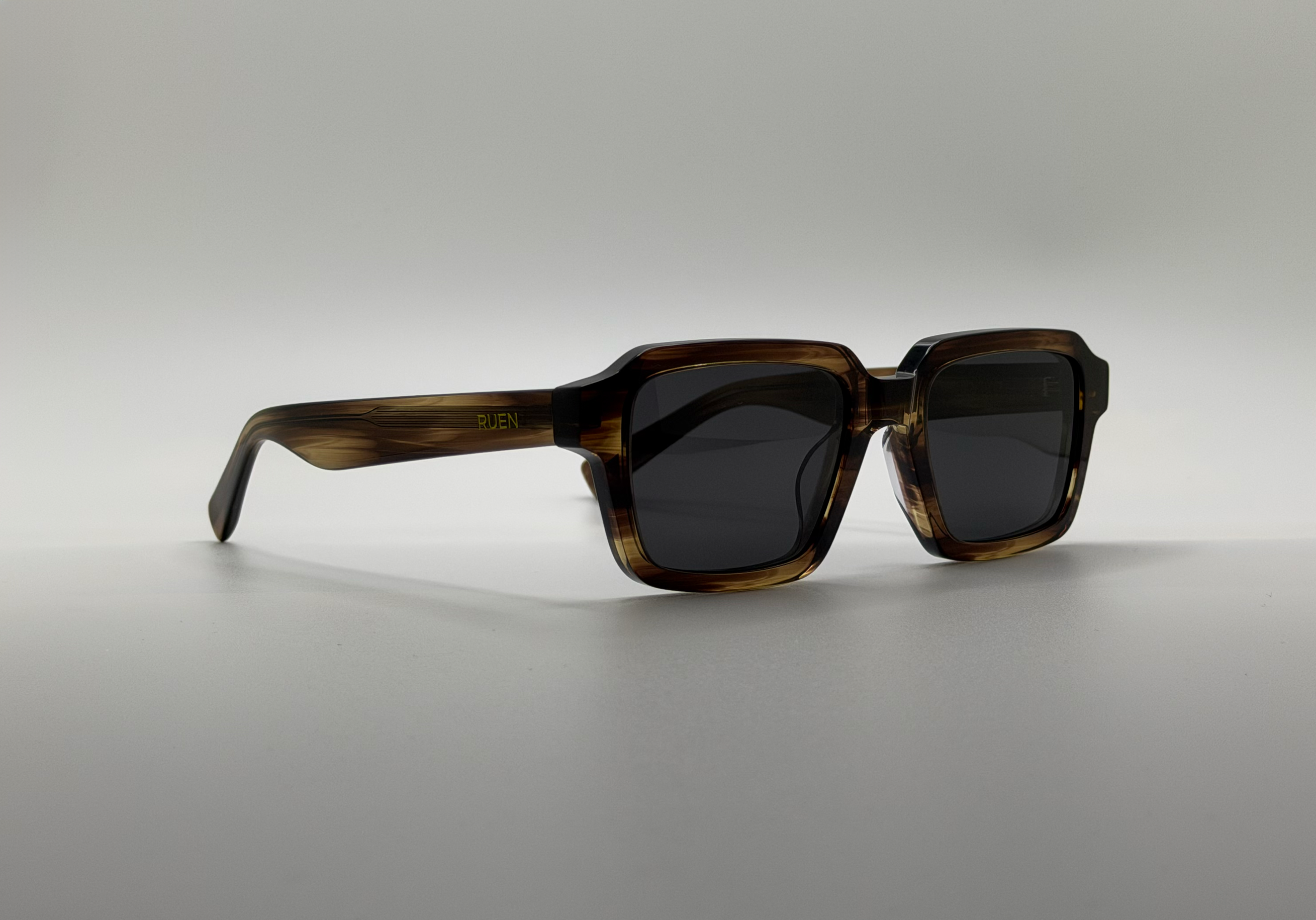 Sunglasses with a tortoiseshell frame on a gray background