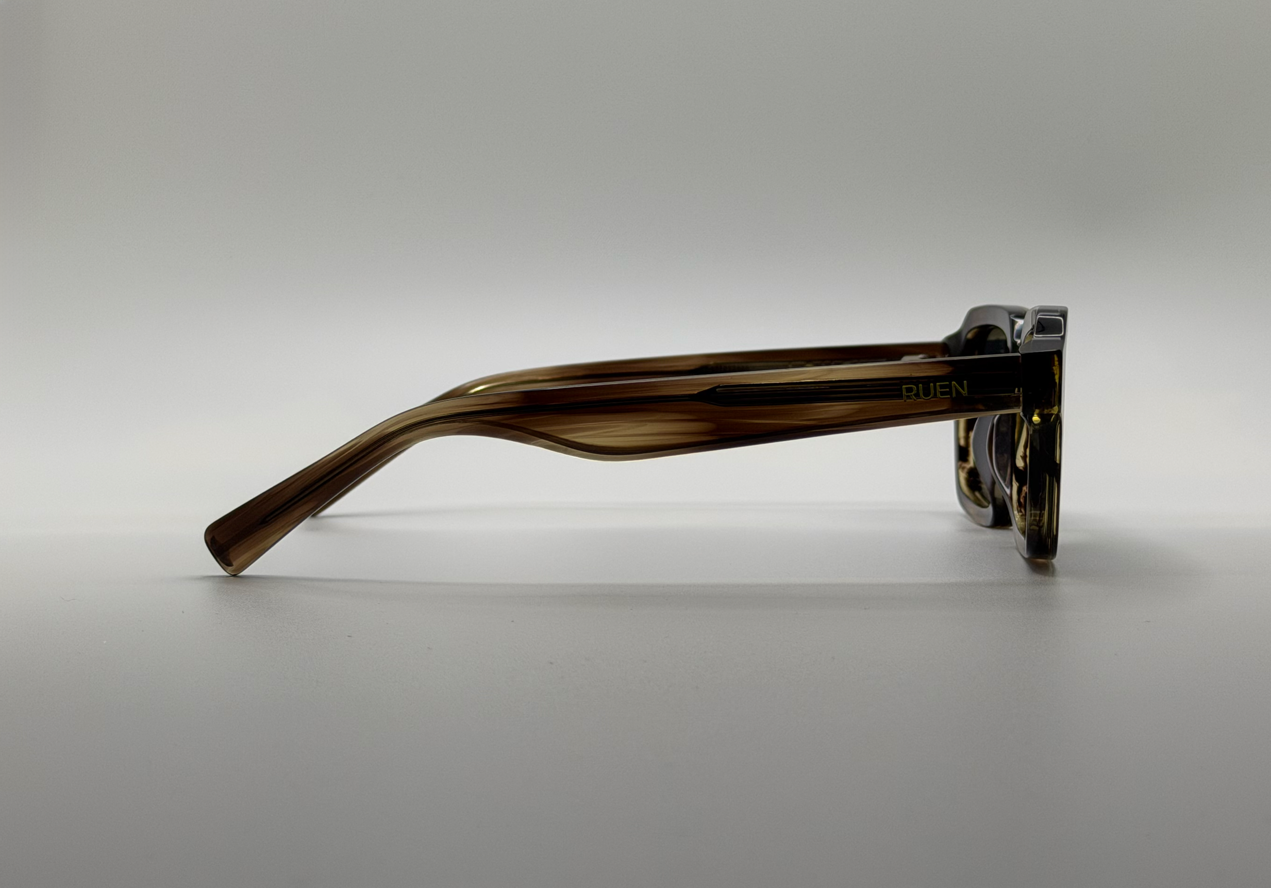 Sunglasses with tortoiseshell frame on a gray background