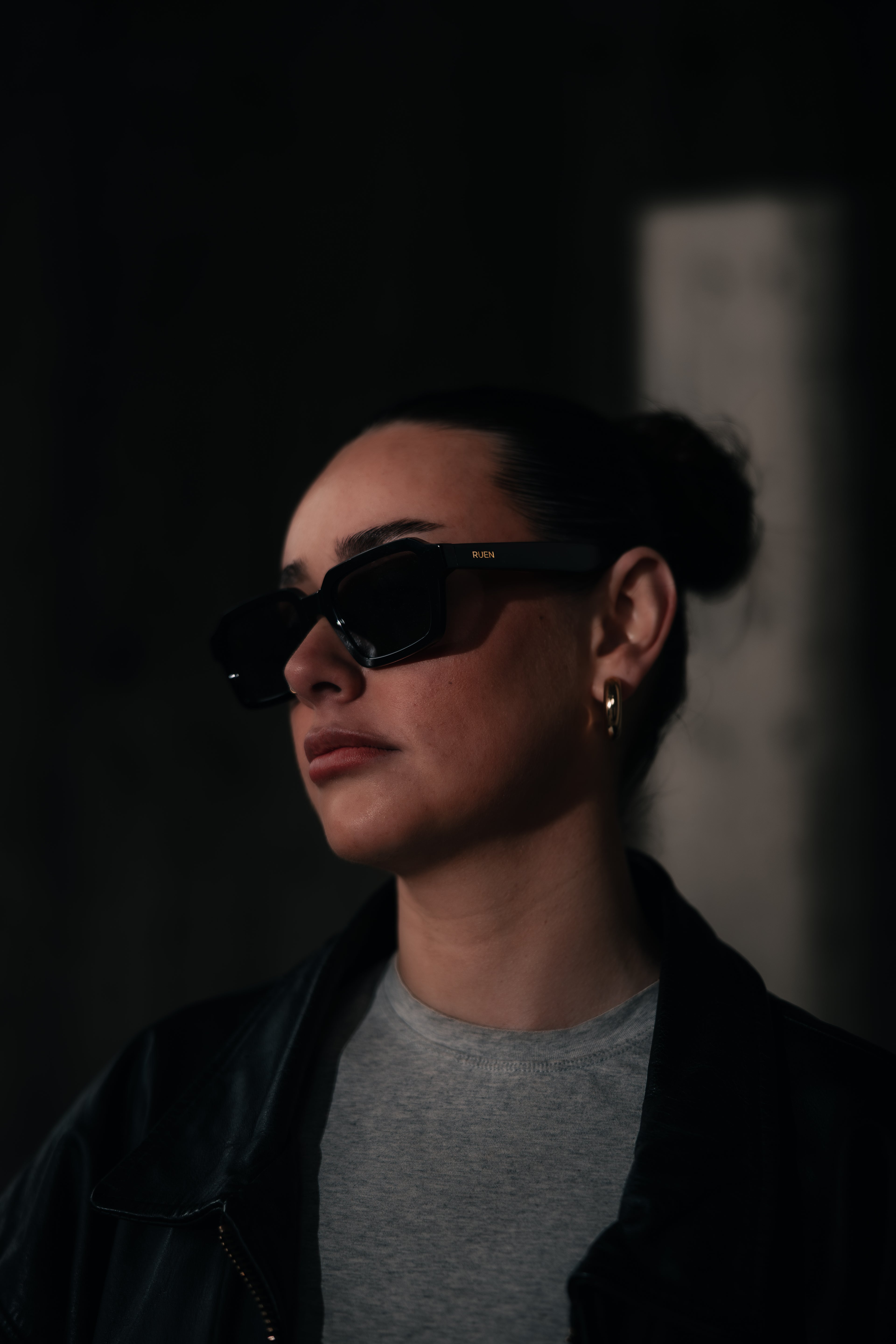 Person wearing sunglasses in a dark setting