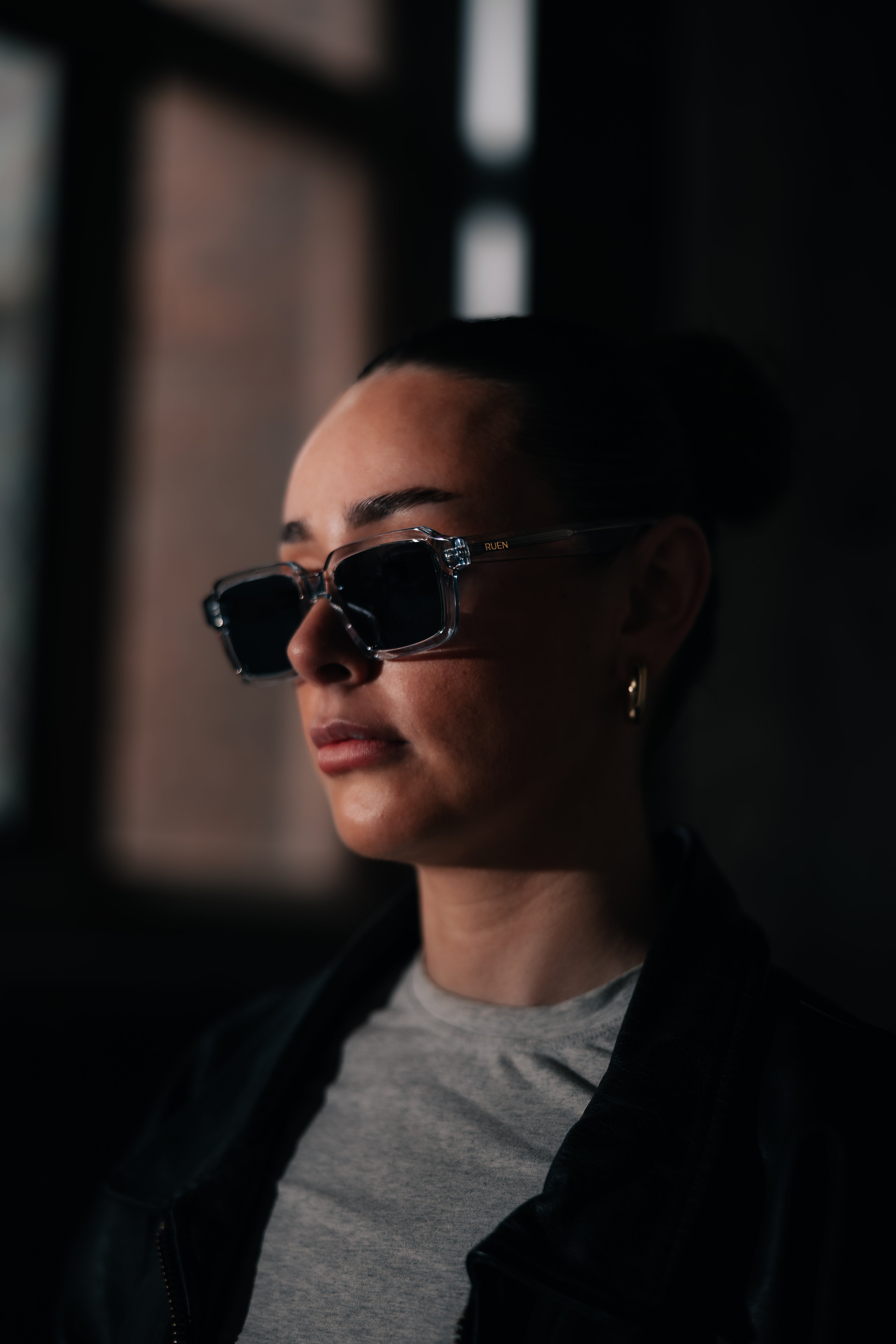 Person wearing sunglasses with a dark background