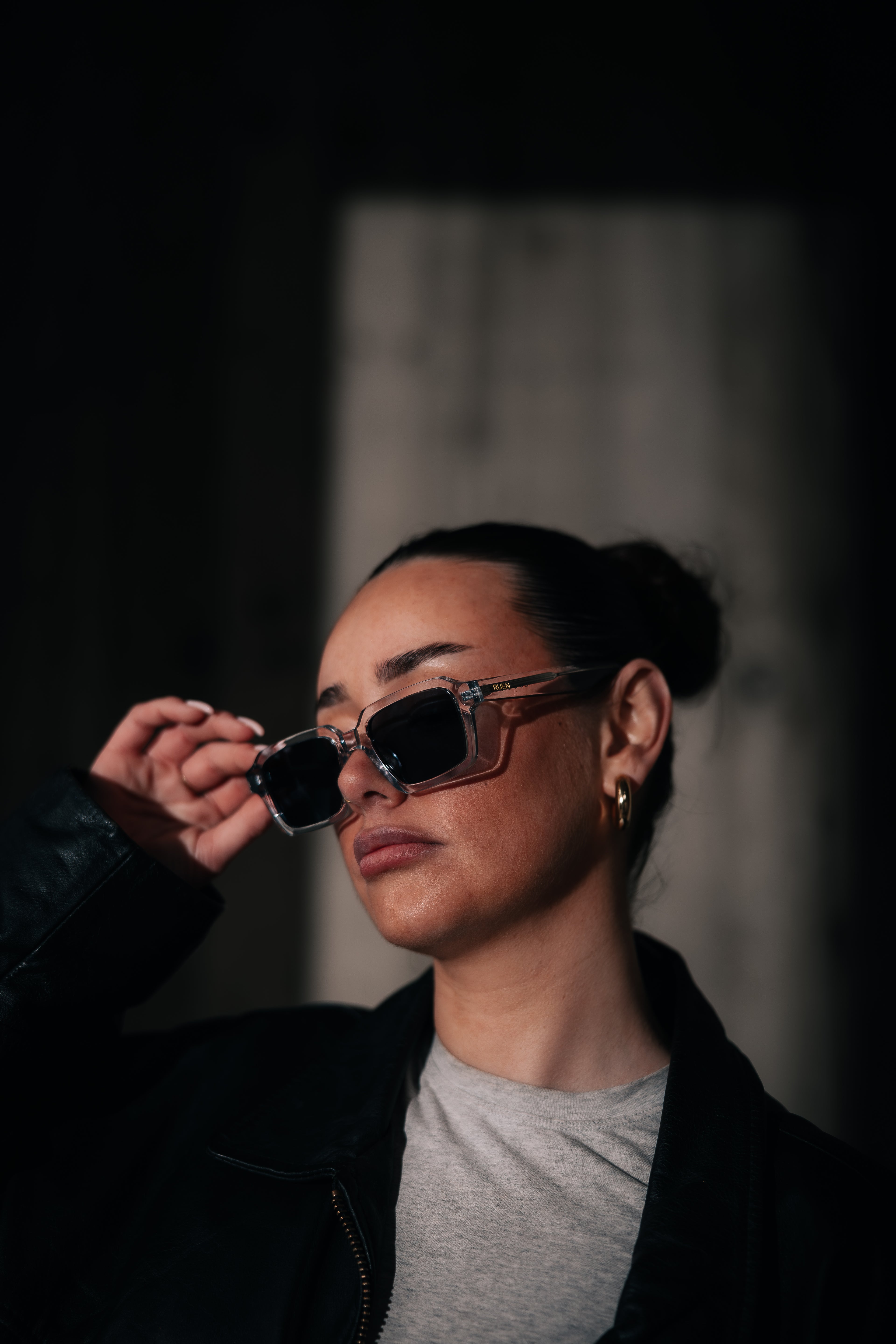 Person wearing sunglasses with a dark background