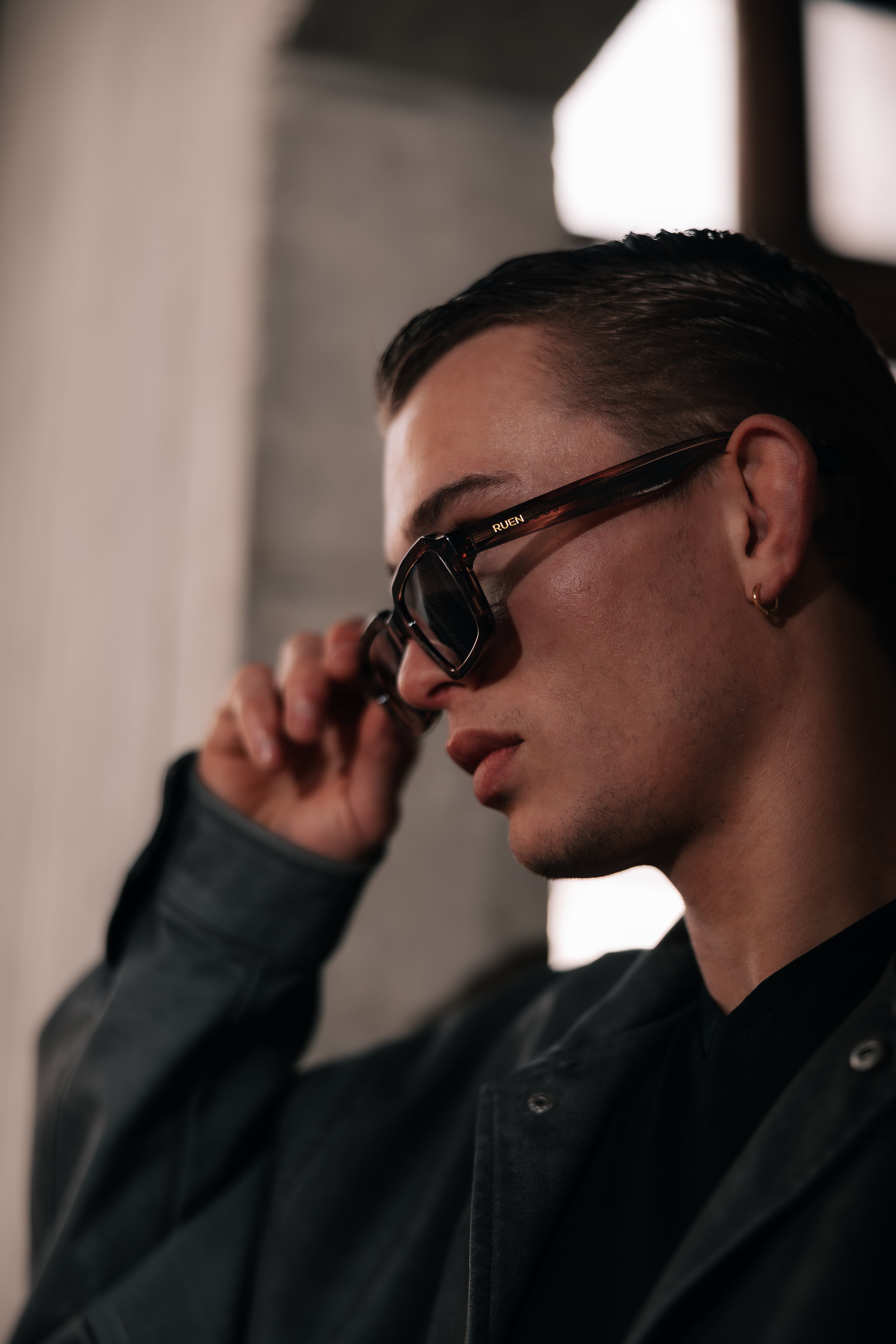 Man wearing sunglasses with a blurred background