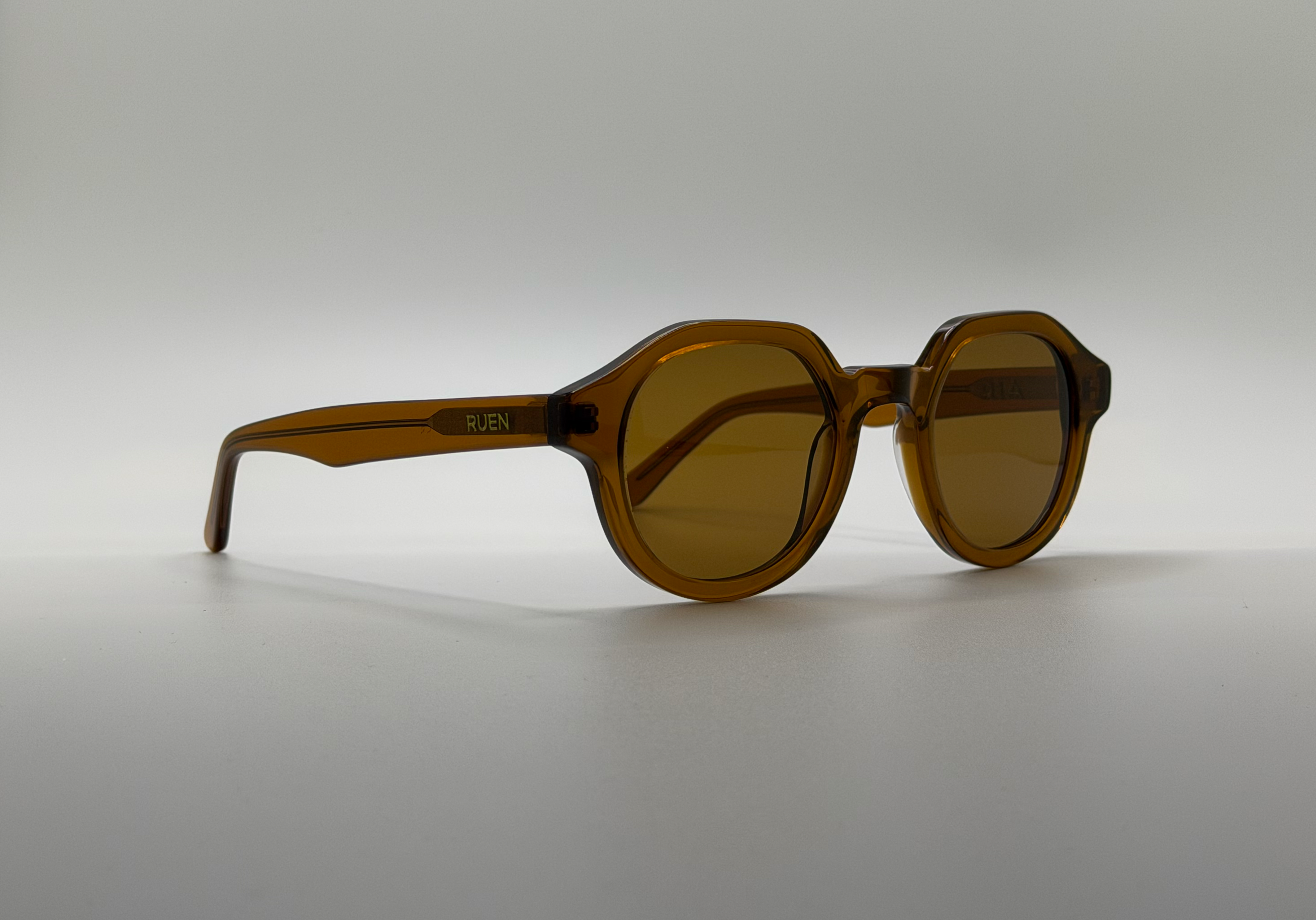 Brown sunglasses on a light gray background