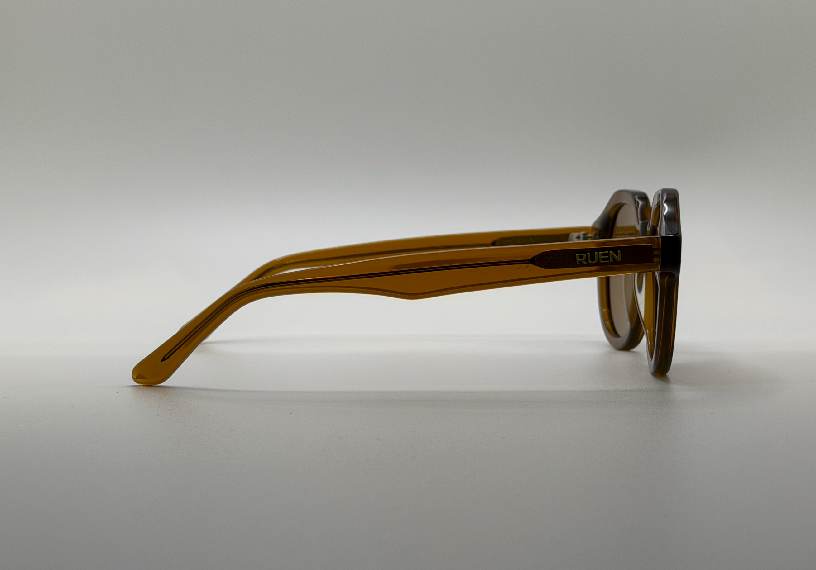 Brown eyeglasses on a light gray background