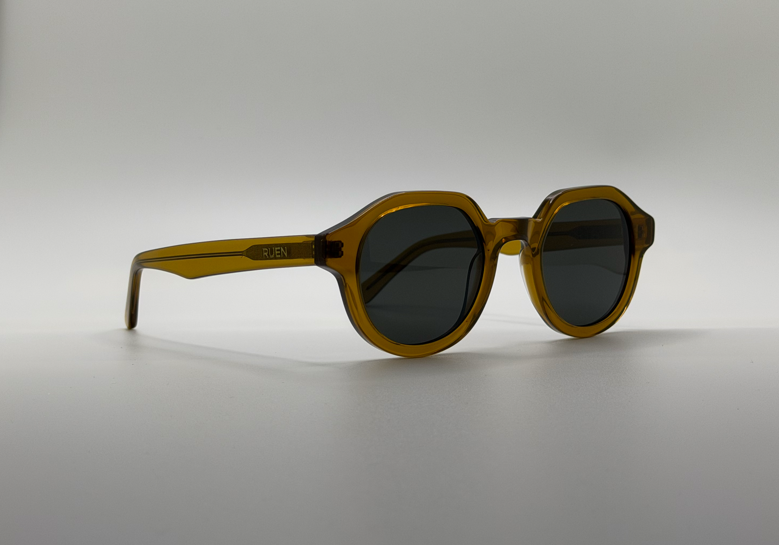Sunglasses with a brown frame on a light gray background