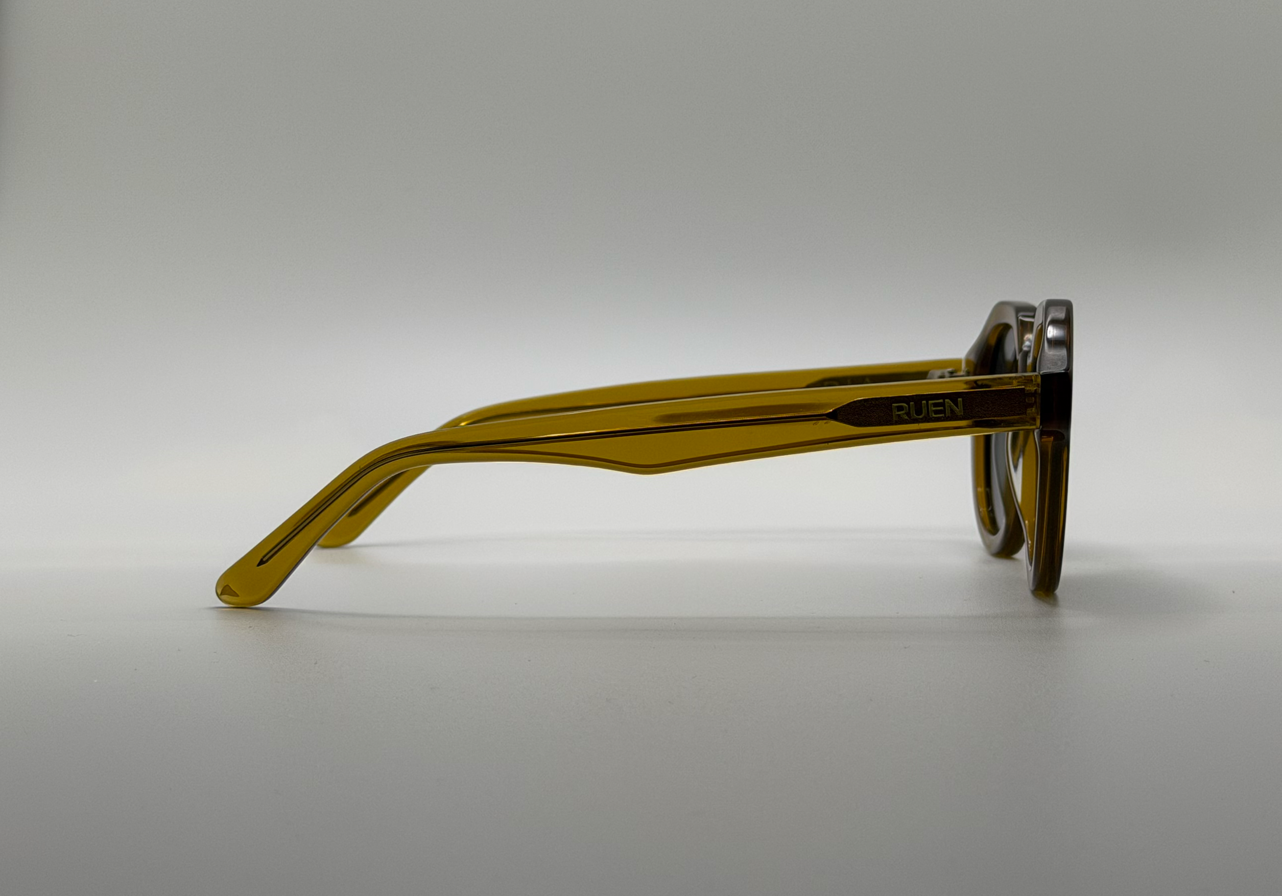 Brown eyeglasses on a light gray background