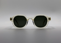 Sunglasses with a clear frame and dark lenses on a gray background