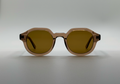 Sunglasses with brown lenses and frames on a light gray background