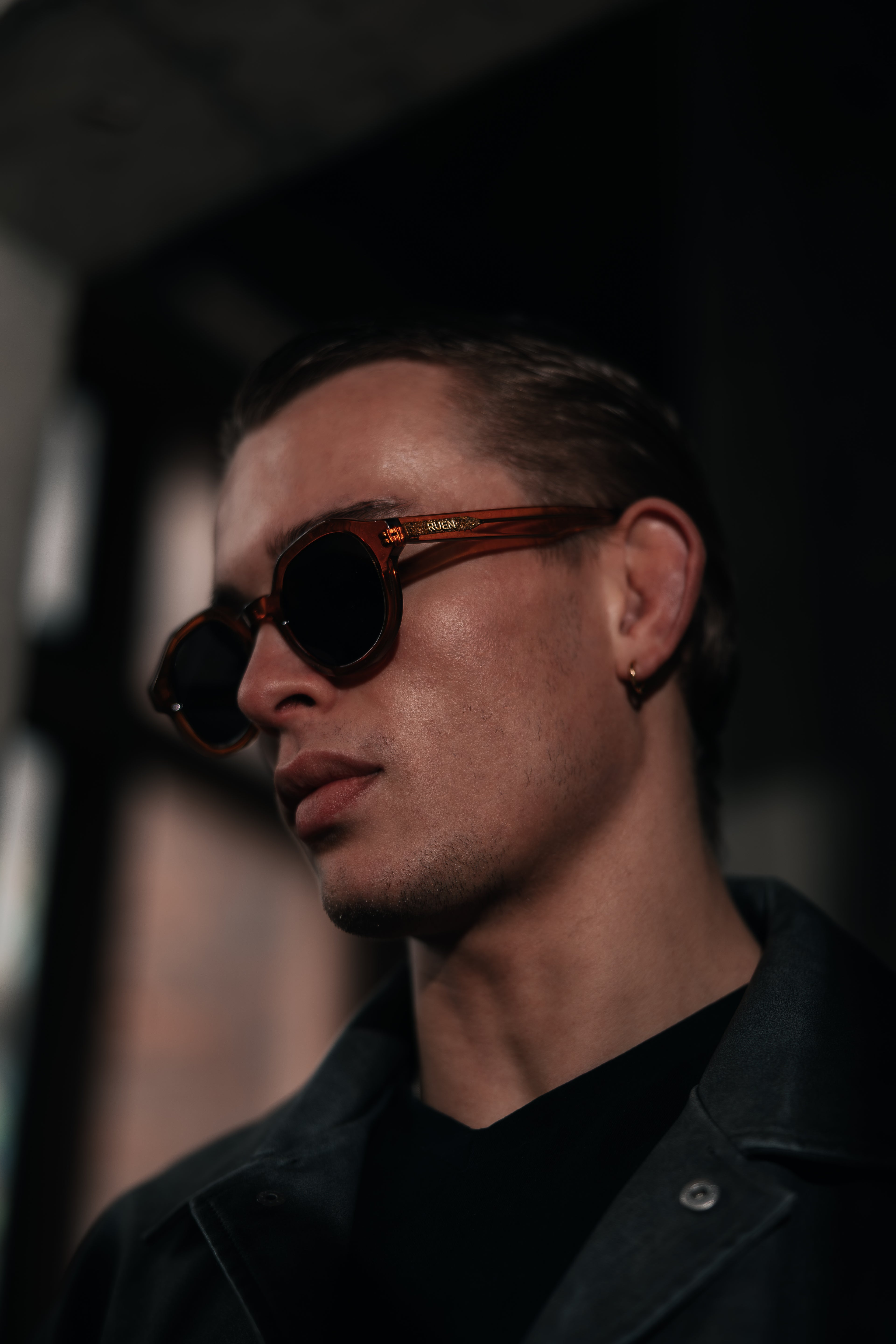 Man wearing sunglasses with a blurred background
