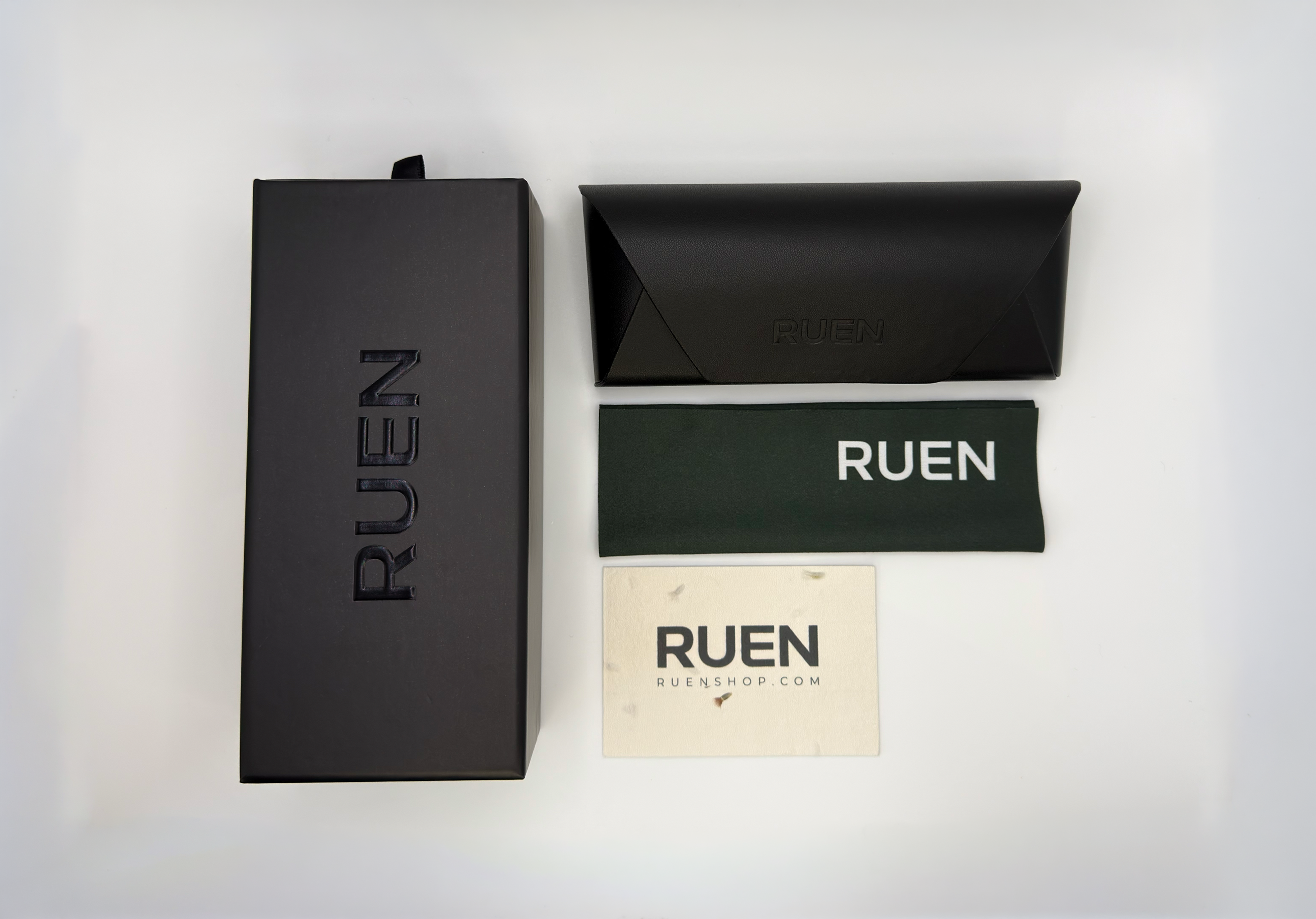 RUEN branded eyewear packaging set on a white background